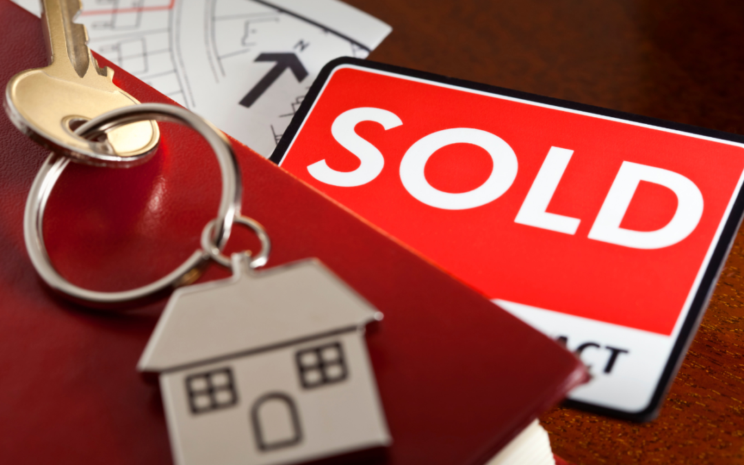 Keys and sold sign for property deeds blog